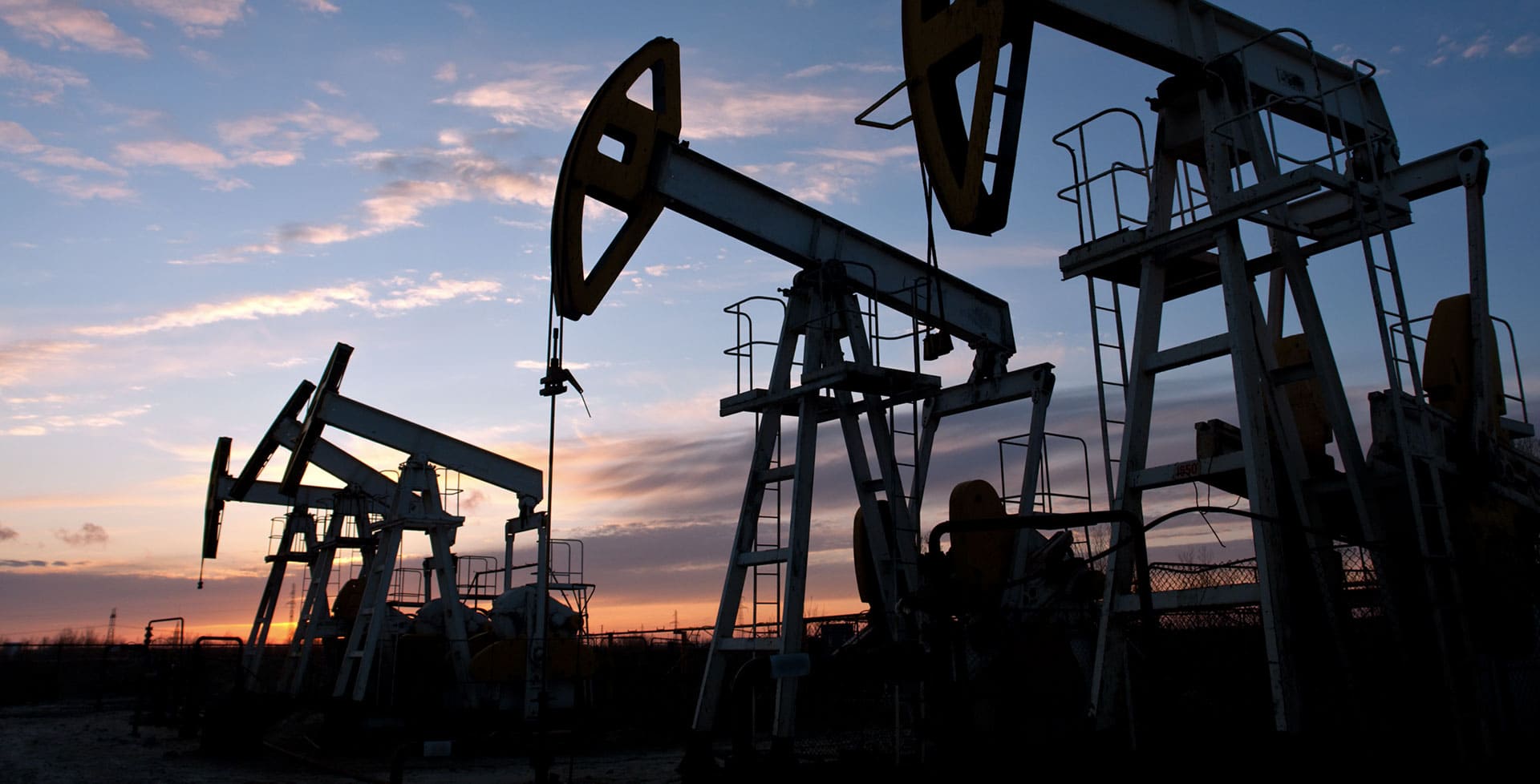 Oil pump silhouettes at dusk