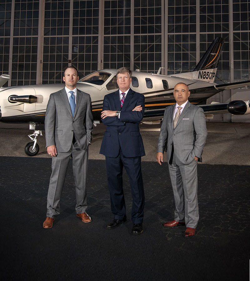 GVI Attorneys in front of firm's plane