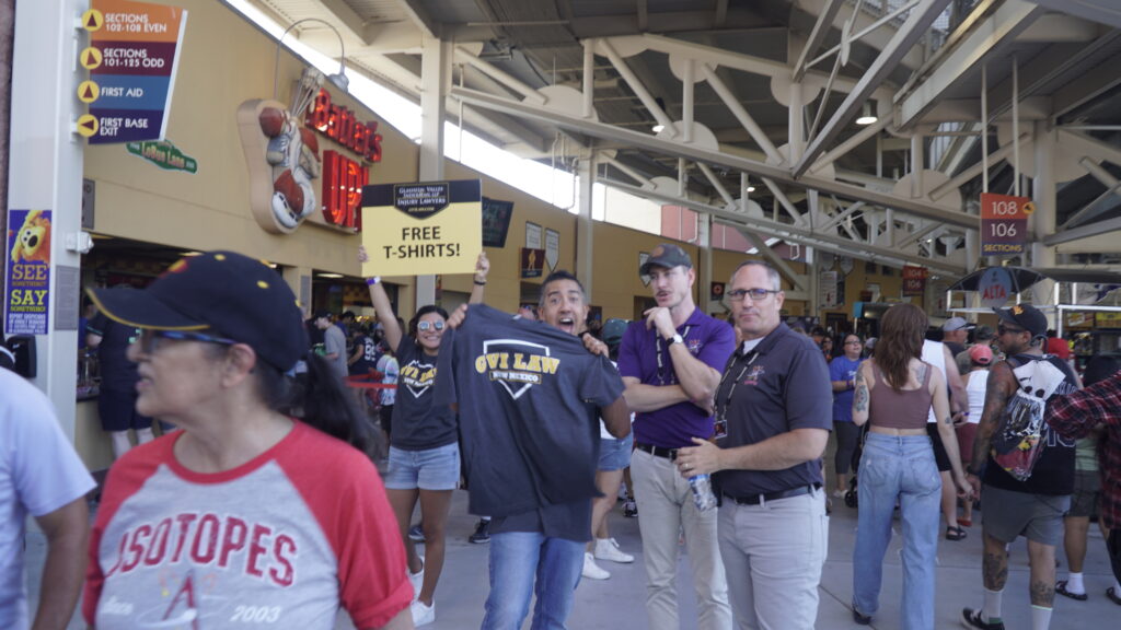 GVILAW Employees handing out t-shirts at the Isotopes Baseball Park in Albuquerque, New Mexico.