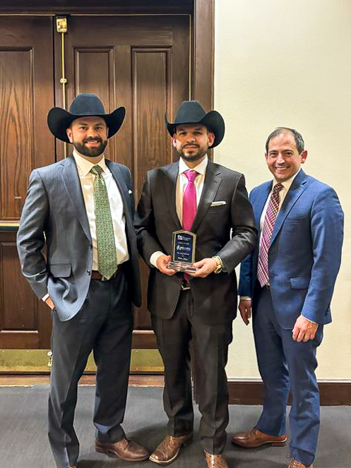 Personal Injury Lawyer Kenny Morris, Senior Partner & Personal Injury Lawyer Pedro Leyva, Personal Injury Lawyer Nick Peña standing together with Pedro's Up and Comer Award in hand.