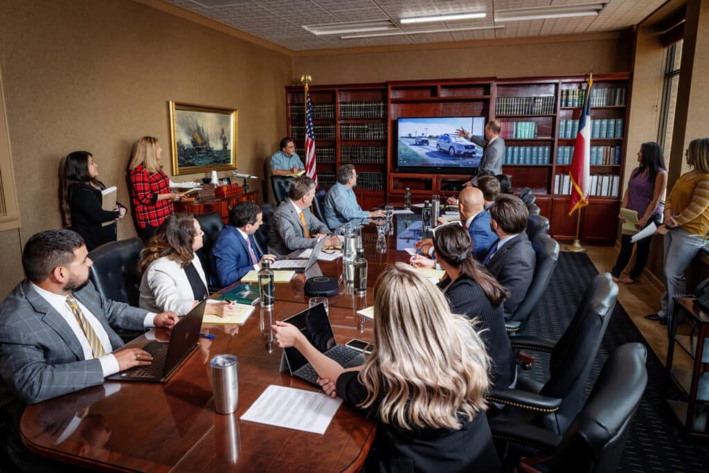 GVI attorneys and case managers looking at a screen during a meeting.