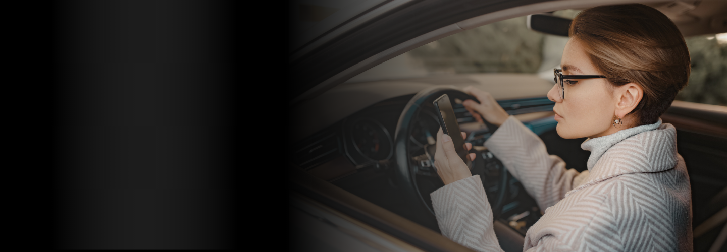 Lady looking at her phone while driving | Picture used for Glasheen, Valles & Inderman Injury Lawyers | Lubbock Distracted Driving Accident Attorney Page