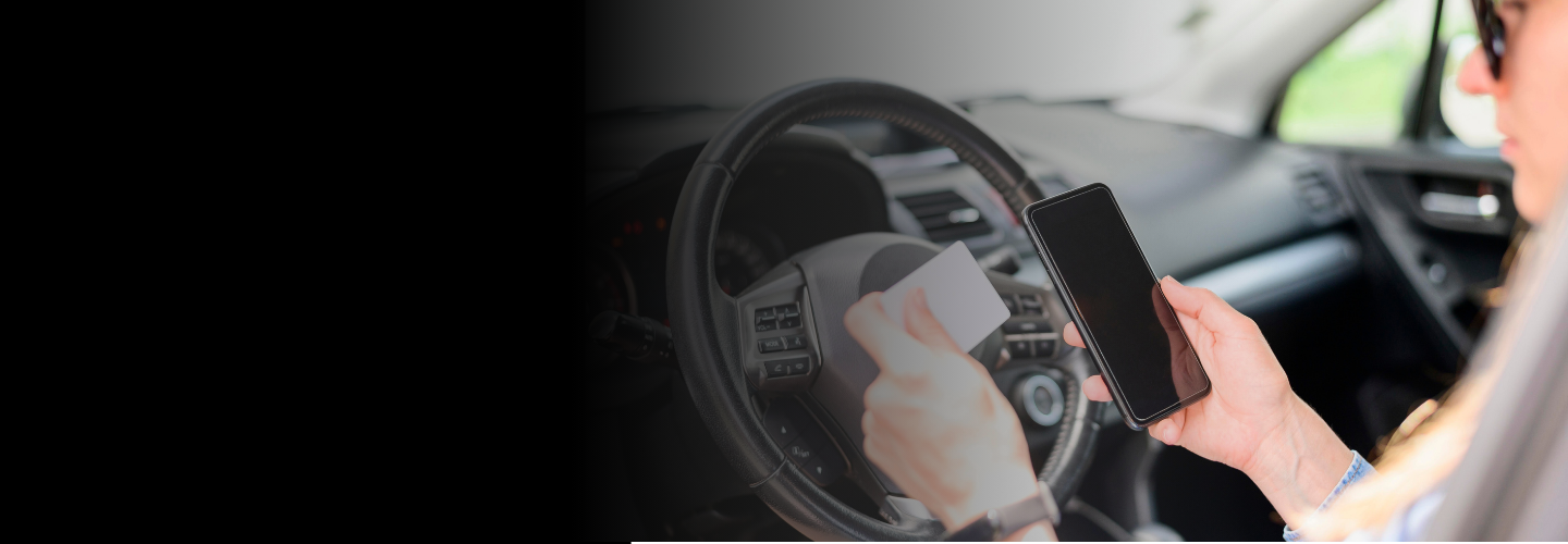 Lady looking at her phone and reading a notecard while driving | Picture used for Glasheen, Valles & Inderman Injury Lawyers | Houston Distracted Driving Accident Attorney Page